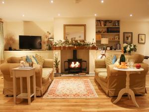 a living room with a couch and a fire place at The Owl House in Bishops Waltham