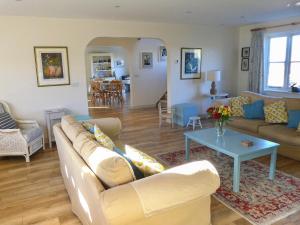 a living room with a couch and a table at The Owl House in Bishops Waltham