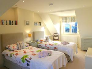a bedroom with two beds with white sheets and a window at The Owl House in Bishops Waltham +28 photos