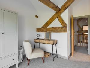 a room with a table and a chair and a desk at The Maddocks - Uk36311 in Whitchurch
