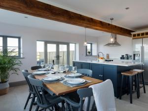 a kitchen and dining room with a wooden table and chairs at The Maddocks - Uk36311 in Whitchurch