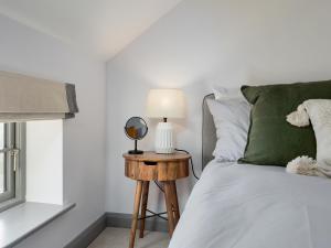 a bedroom with a bed and a table with a mirror at The Maddocks - Uk36311 in Whitchurch +9 photos