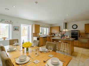 a kitchen and dining room with a table and chairs at Cunliffe Cottage in Hathersage +22 photos