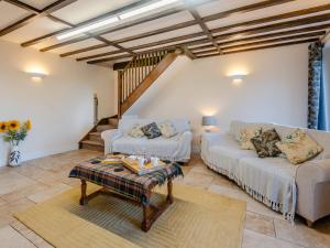a living room with two couches and a table at One Chainbridge Barns in Skegness