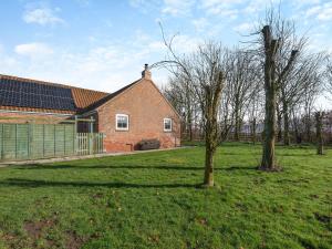 a brick house with a tree in the yard at One Chainbridge Barns in Skegness