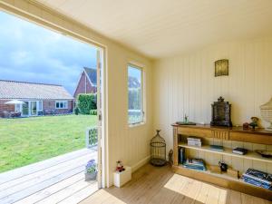 a room with a large window and a view of a yard at Holly Lodge in Hemsby