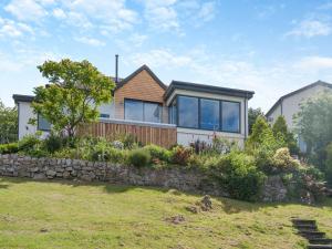 a house with a stone retaining wall at Berkeley in Kippford