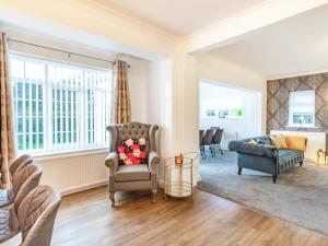 a living room with a chair and a couch at The Gables in Bridlington