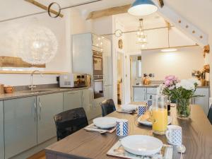 a kitchen and dining room with a wooden table at Stone Barn - Ukc3594 in Minehead +23 photos