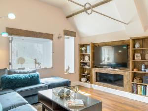 a living room with a couch and a tv at Stone Barn - Ukc3594 in Minehead