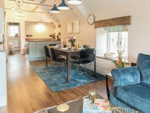 a kitchen and living room with a table and chairs at Stone Barn - Ukc3594 in Minehead
