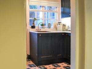 a kitchen with a sink and a window at Yew Tree House Cottage in New Romney +6 photos