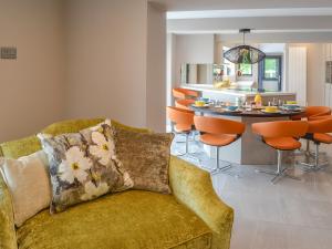 a living room and kitchen with a couch and a table at Tan Y Fford in Bangor +21 photos