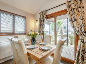 a dining room with a wooden table and chairs at River Retreat-B6842 in Brundall +19 photos