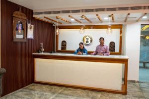 a man and a woman standing at a bar at Hotel Bobina in Gorakhpur