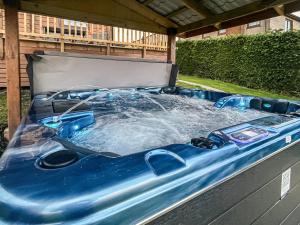 a jacuzzi tub in a gazebo at Coo Lodge - Uk48430 in Falkirk