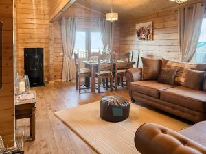 a living room with a couch and a table at Coo Lodge - Uk48430 in Falkirk