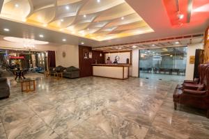a lobby with a reception desk and a lobby at Hotel Bobina in Gorakhpur