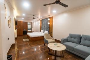 a living room with a couch and a bed at Hotel Bobina in Gorakhpur
