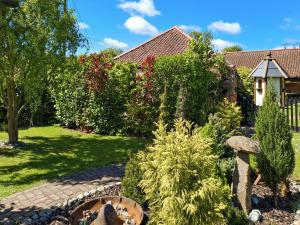 a garden with a stone pathway and a house at Bockety Barn in Stalham +11 photos