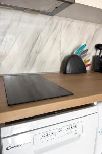 a stove top oven with a counter top at Rona Vista Suites cozy veranda in Polychrono