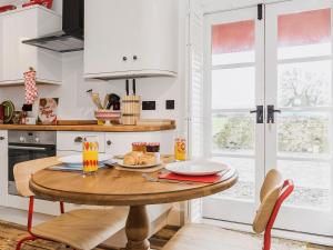 a kitchen with a wooden table with food on it at Ty Macsen in Llanwnda