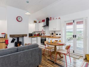 a living room with a couch and a table at Ty Macsen in Llanwnda