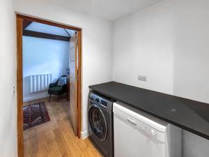 a laundry room with a washer and dryer at Eagles Nest in Guildford