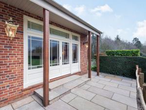 a brick house with white doors and a patio at The Pavilion in Willoughby