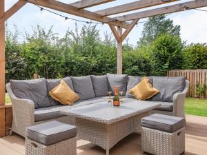 a patio with a couch and a table at Lucky's Stable - Uk34101 in Chichester