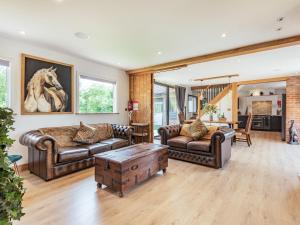a living room with leather furniture and a table at Lucky's Stable - Uk34101 in Chichester