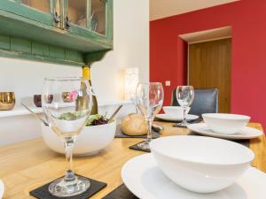a wooden table with wine glasses on top of it at The Barn At Grislow Field in Curbar