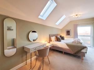 a bedroom with a bed and a desk and a mirror at The Birches - Ukc4619 in Dunholme