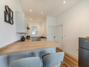 a kitchen with a wooden counter top and two chairs at Bolton Farm in Durham