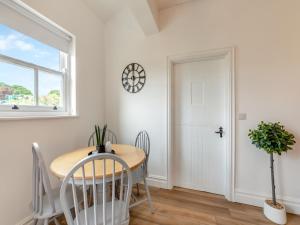 a dining room with a table and chairs and a window at Bolton Farm in Durham