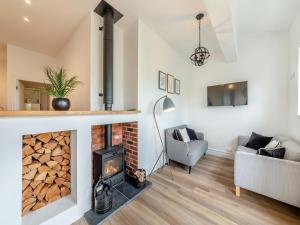 a living room with a fireplace and a couch at Bolton Farm in Durham