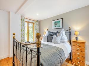 a bedroom with a bed and a window at The Hayloft - Ukc1038 in Hickling +13 photos
