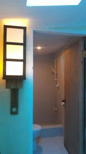 a bathroom with a toilet and a window at Gomez Guest House in Tagbilaran City +45 photos