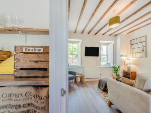 a room with a bed and a couch and a tv at Dyffryn Glanffrwd Mill in Cellan