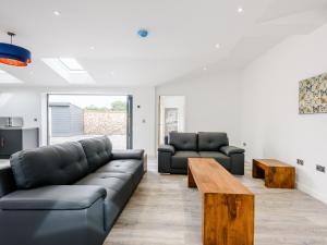 a living room with a couch and a table at Marshall Cottage in Santon +13 photos