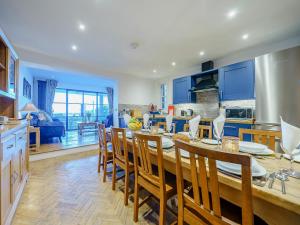 a kitchen and dining room with a table and chairs at Ystwyth House in Borth