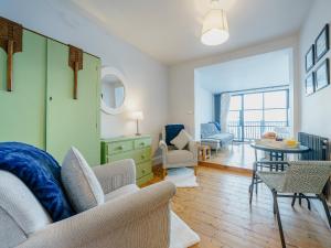 a living room with chairs and a table at Ystwyth House in Borth +26 photos