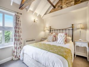a bedroom with a bed and a window at The Hayloft - Uk47153 in Burgh le Marsh