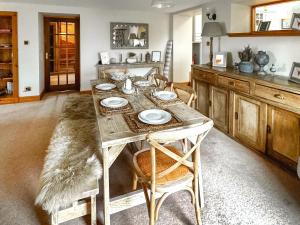 a kitchen with a table with plates on it at Rubha Lodge in Shieldaig +20 photos