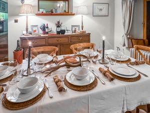 a table with plates and dishes on top of it at Rubha Lodge in Shieldaig