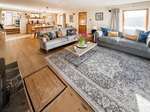 a living room with a couch and a table at Rubha Lodge in Shieldaig
