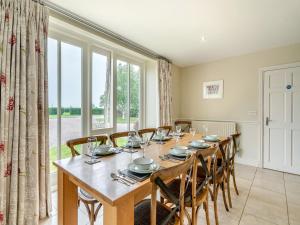 a dining room with a table and chairs and a large window at Coach House - Uk49887 in Preston