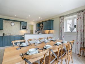 a kitchen and dining room with a wooden table and chairs at Coach House - Uk49887 in Preston
