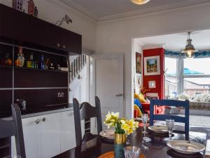 a kitchen and dining room with a table and chairs at Fronks House in Harwich