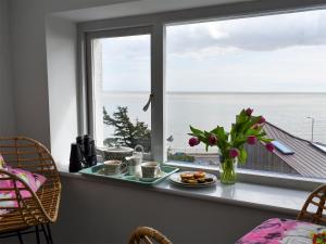 a table with food and flowers in front of a window at Fronks House in Harwich +19 photos